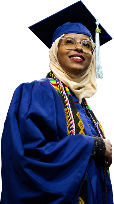 Graduating woman in full robe and cap with a hijab