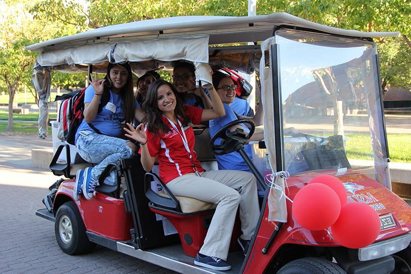 密歇根州立大学丹佛高尔夫球车里的学生和团队成员